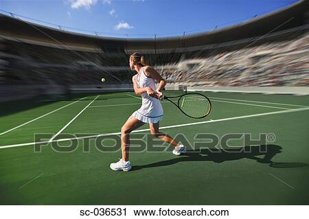 Stock Image - Tennis player hitting backhand return. Fotosearch
