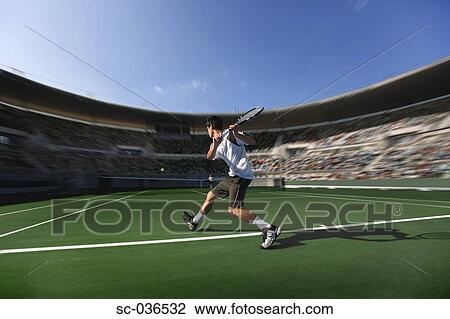 Tennis player hitting backhand return View Large Photo Image Stock Image - Tennis player hitting backhand return. Fotosearch