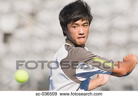 Stock Photo - Tennis player hitting backhand return. Fotosearch