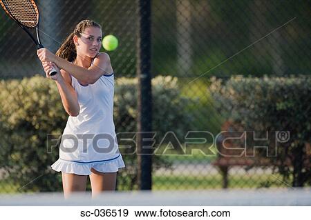 Stock Photo - Tennis player hitting backhand return. Fotosearch