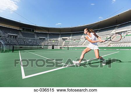 Tennis player hitting backhand return View Large Photo Image Stock Photography - Tennis player hitting backhand return. Fotosearch