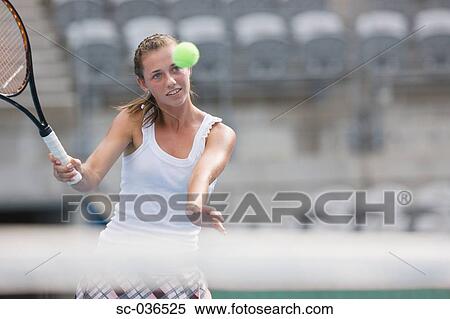 Stock Photography - Tennis player hitting forehand return. Fotosearch