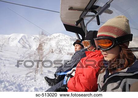Three Snowboarders on a Chairlift View Large Photo Image Stock Image - Three Snowboarders on a Chairlift. Fotosearch