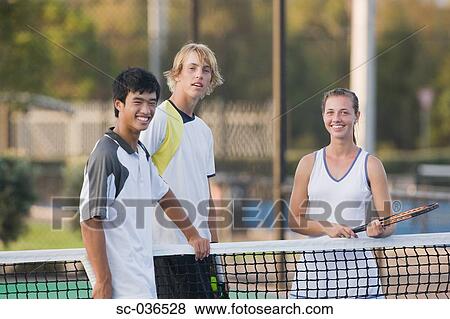 Three tennis players standing on court View Large Photo Image Stock Photo - Three tennis players standing on court. Fotosearch