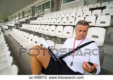 Stock Image - Trainer checking timer. Fotosearch