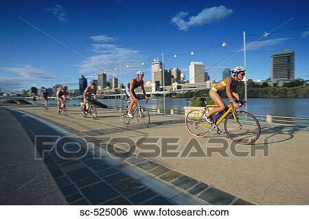Stock Photograph - Triathloners Cycling. Fotosearch