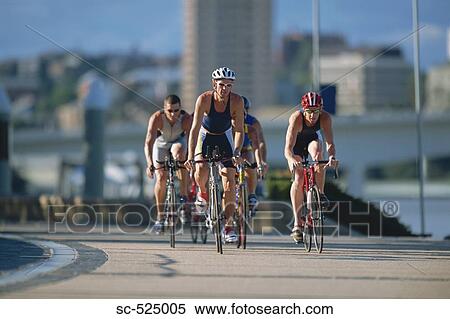 Stock Photography - Triathloners Cycling. Fotosearch