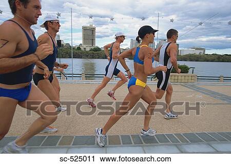 Stock Image - Triathloners Running. Fotosearch