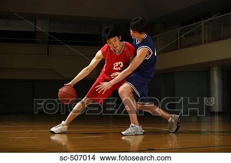 Picture - Two Asian Boys Playing Basketball. Fotosearch