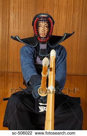 Stock Image - Two Kendo Fencers Sparring. Fotosearch