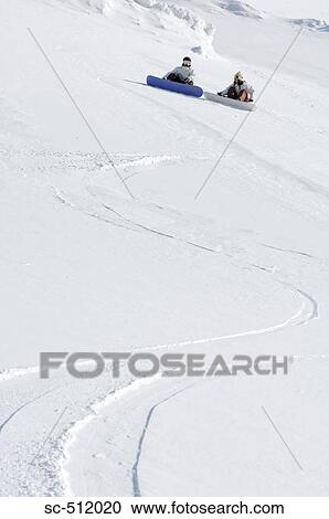Stock Image - Two snowboarders relaxing. Fotosearch