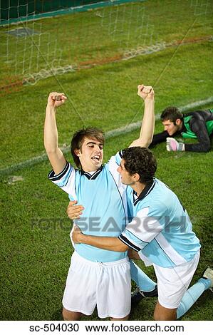 Stock Image - Two Soccer Players Celebrating a Goal. Fotosearch