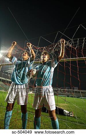 Stock Photo - Two Soccer Players Celebrating a Goal. Fotosearch