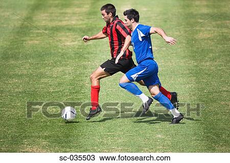 Stock Image - Two soccer players challenging for the ball. Fotosearch