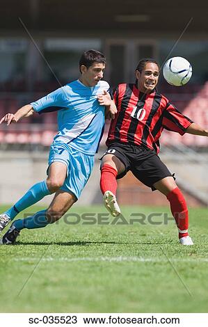 Stock Image - Two soccer players challenging for the ball. Fotosearch