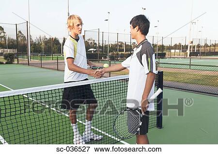 Two tennis players shaking hands at net View Large Photo Image Stock Photo - Two tennis players shaking hands at net. Fotosearch