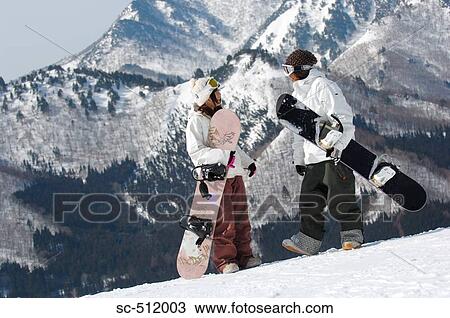 Two young Asian snowboarders with mountain backdrop View Large Photo Image Stock Image - Two young Asian snowboarders with mountain backdrop. Fotosearch