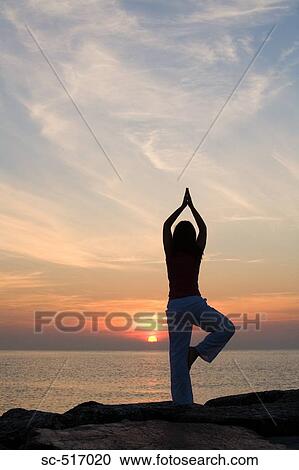 Stock Image - Woman Excersizing Near the Sea. Fotosearch