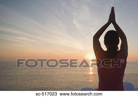 Stock Image - Woman Excersizing Near the Sea. Fotosearch