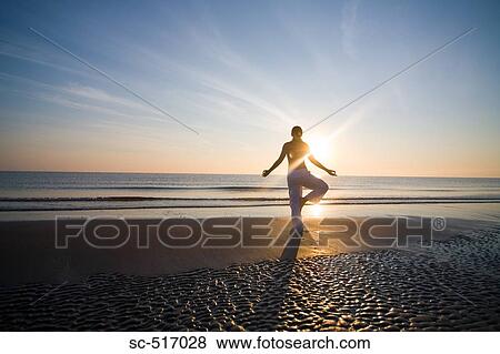 Stock Photo - Woman Excersizing On the Beach. Fotosearch