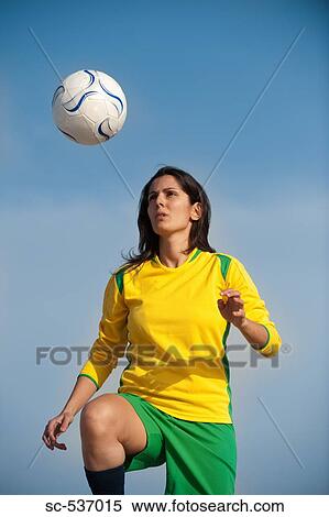 Woman juggling soccer ball View Large Photo Image Stock Photography - Woman juggling soccer ball. Fotosearch