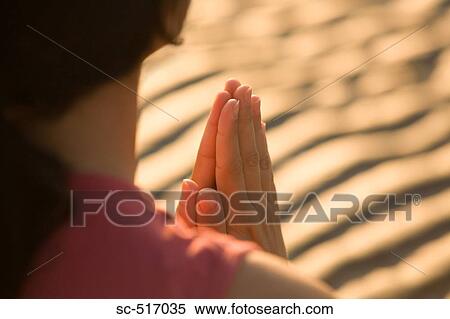 Stock Photography - Woman Meditating On the Beach. Fotosearch