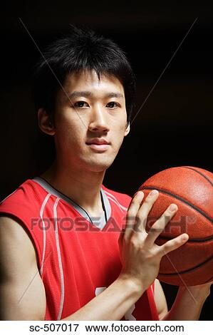 Stock Photo - Young Asian basketball player. Fotosearch