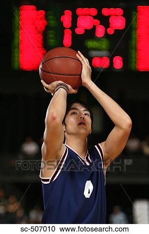 Young Asian basketball player with ball View Large Photo Image Stock Image - Young Asian basketball player with ball. Fotosearch