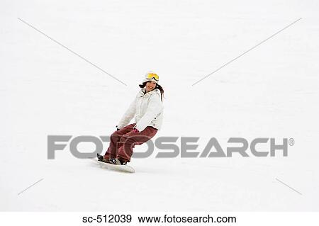 Stock Photo - Young Asian snowboarder in action. Fotosearch