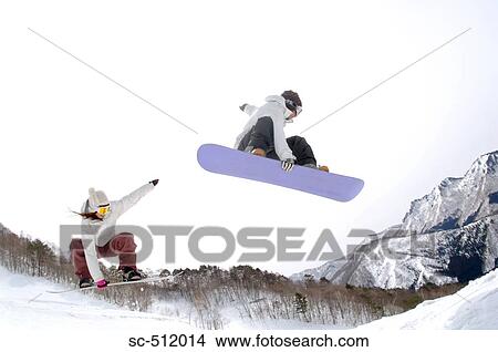 Young Asian snowboarders mid air View Large Photo Image Picture - Young Asian snowboarders mid air. Fotosearch