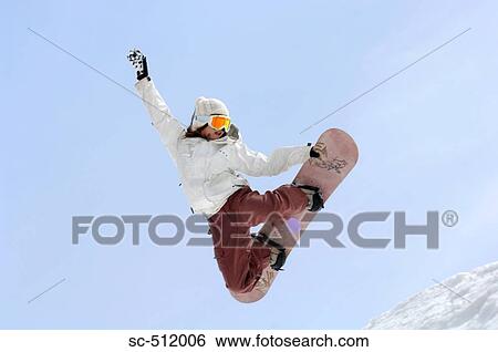Young female snowboarder mid air View Large Photo Image Stock Photograph - Young female snowboarder mid air. Fotosearch