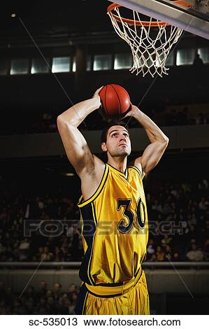 Young man holding basketball over his head View Large Photo Image Stock Image - Young man holding basketball over his head. Fotosearch
