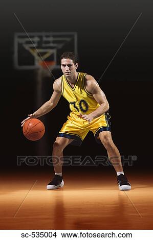 Young man playing basketball View Large Photo Image Picture - Young man playing basketball. Fotosearch