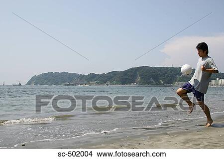 Young Man Playing Soccer On A Beach View Large Photo Image Picture - Young Man Playing Soccer On A Beach. Fotosearch