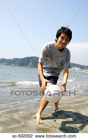 Young Man Playing Soccer On A Beach View Large Photo Image Stock Image - Young Man Playing Soccer On A Beach. Fotosearch