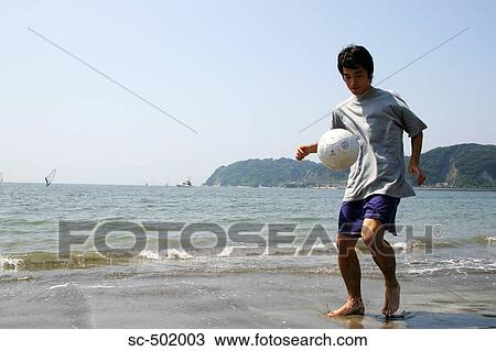 Young Man Playing Soccer On A Beach View Large Photo Image Stock Image - Young Man Playing Soccer On A Beach. Fotosearch