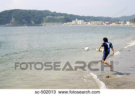 Young Man Playing Soccer On A Beach View Large Photo Image Stock Image - Young Man Playing Soccer On A Beach. Fotosearch