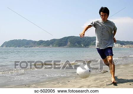 Young Man Playing Soccer On A Beach View Large Photo Image Stock Photography - Young Man Playing Soccer On A Beach. Fotosearch