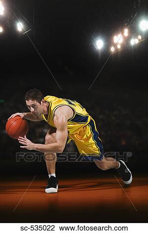 Young man playing with basketball View Large Photo Image Stock Image - Young man playing with basketball. Fotosearch