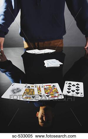 Young man showing royal flush at table View Large Photo Image Stock Photography - Young man showing royal flush at table. Fotosearch