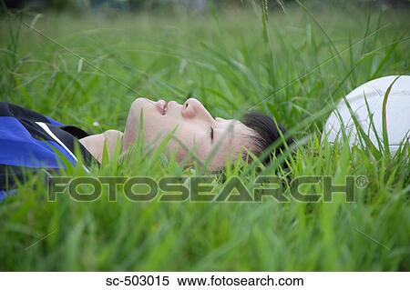 Young Man Sleeping Next To A Soccer Ball In a Field View Large Photo Image Stock Photography - Young Man Sleeping Next To A Soccer Ball In a Field. Fotosearch