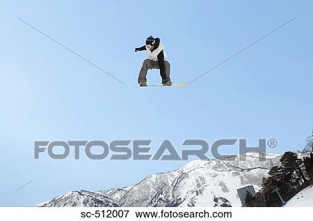 Stock Photo - Young snowboarder airborne. Fotosearch
