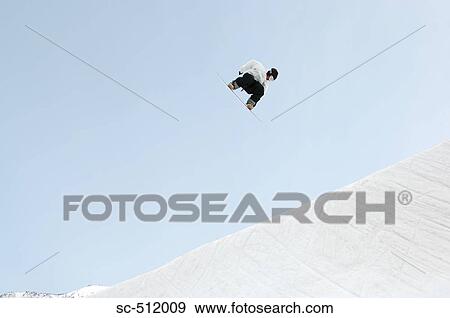 Stock Photo - Young snowboarder airborne. Fotosearch