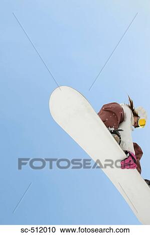 Young snowboarder in action View Large Photo Image Stock Image - Young snowboarder in action. Fotosearch