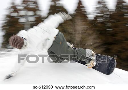 Stock Image - Young snowboarder in action. Fotosearch