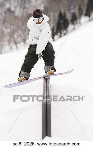 Stock Photograph - Young snowboarder in action. Fotosearch
