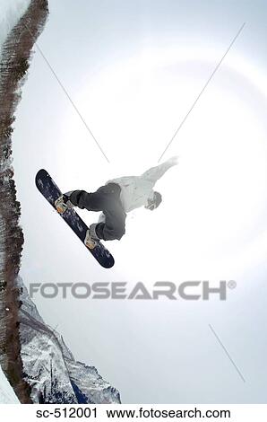 Young snowboarder mid air View Large Photo Image Stock Image - Young snowboarder mid air. Fotosearch