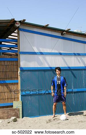 Young Soccer Player Posing Next To A Shack View Large Photo Image Stock Image - Young Soccer Player Posing Next To A Shack. Fotosearch