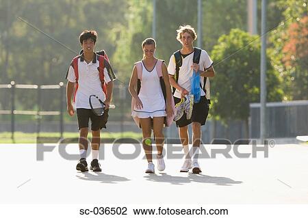 Young tennis players walking with equipment View Large Photo Image Stock Image - Young tennis players walking with equipment. Fotosearch