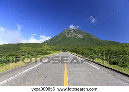 Stock Photograph - Road through the countryside, Hokkaido. Fotosearch